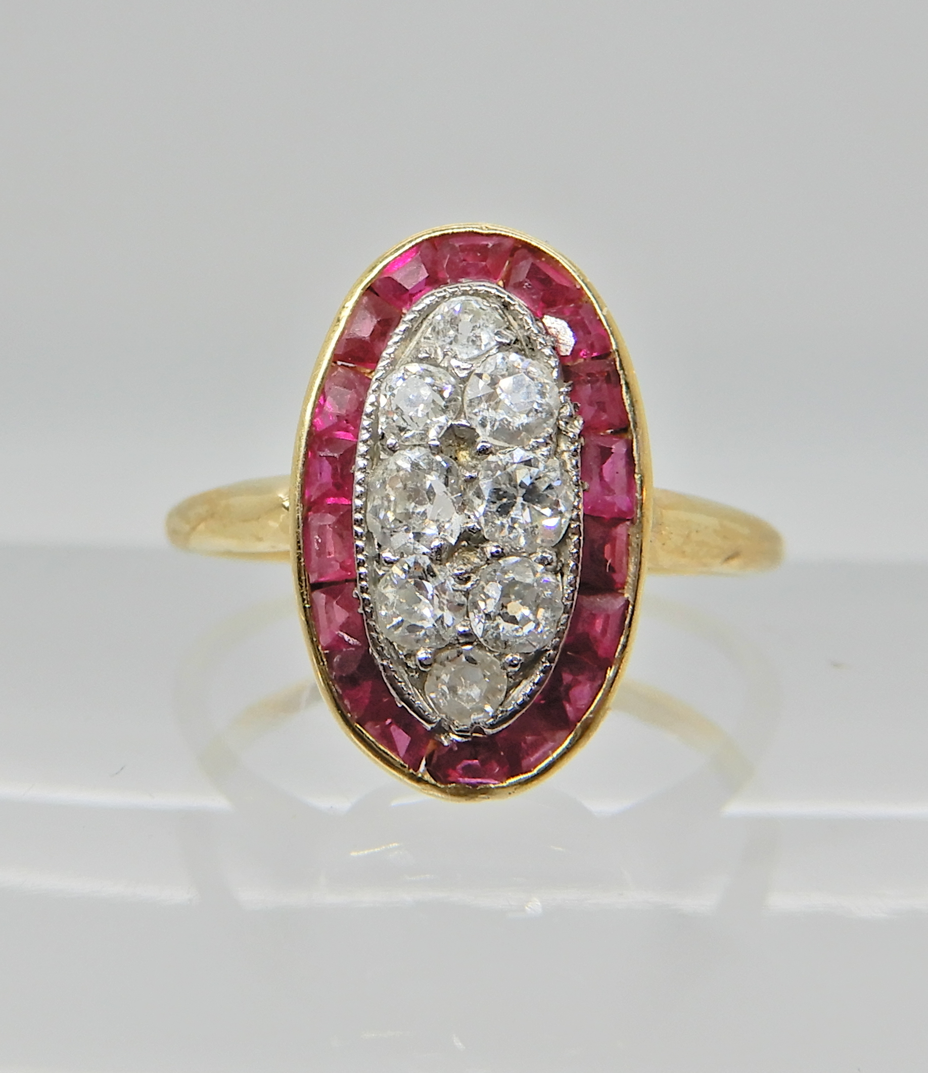 An 18ct gold ruby and diamond plaque ring, finger size N1/2, weight 2.6gms, with an insurance