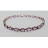 A 9ct white gold amethyst bracelet, length 18.5cm, weight 5.2gms