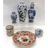 A Chinese blue and white vase depicting a bird amongst flowers, a small dragon vase, a lidded jar