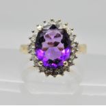 A 9ct gold amethyst and diamond cluster ring, estimated approx diamond content 0.25cts, finger