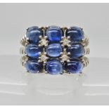 A 9ct white gold cabouchon sapphire and diamond ring, sapphires approx 5mm x 3.7mm x 2.9mm, finger