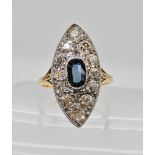 A bright yellow metal old cut diamond and sapphire ring of marquis shape set with estimated approx