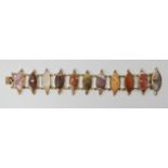 A yellow metal mounted Scottish agate specimen bracelet, with eleven marquis shaped agate panels,