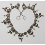 A gilded white metal Gothic design necklace with lion heads and 'Pan' grotesque masks and roses,