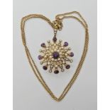 A 9ct amethyst and pearl Edwardian pendant brooch on a 9ct chain, length of pendant 3.7cm, chain