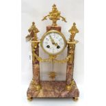 A French pink marble and ormolu mantle clock with enamelled dial