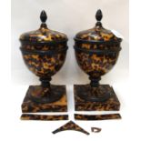 A pair of wooden urns and covers with faux tortoiseshell veneer, (damage and restoration), (2), 34cm