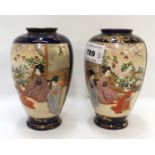 A pair of Satsuma vases, decorated with figures in a landscape setting, 12cm high