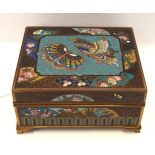 A Japanese cloisonne hinged box decorated with butterflies and flowers on a scrolling group, 10.