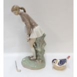 A Lladro figure of a girl playing golf and a Royal Crown Derby bird paperweight (2)