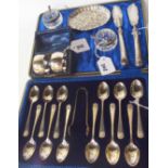 A lot comprising a cased set of twelve silver teaspoons with tongs, Sheffield 1911, with assorted