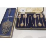 A lot comprising a cased set of silver coffee spoons with tongs, Sheffield 1930 and a white metal