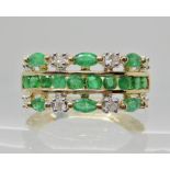 A 9ct gold three row emerald and diamond dress ring, estimated approx diamond content 0.16cts,