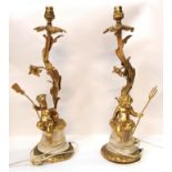A pair of gilded cherub table lamps on onyx plinths and ormolu bases, 47.5cm high