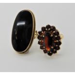 A 9ct gold onyx ring finger size M1/2, and a garnet cluster ring finger size M, combined weight 10.