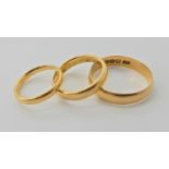 Three 18ct gold wedding rings, finger sizes V1/2, N1/2 and I (for India) weight combined approx 10.