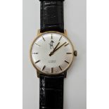 A 9ct gold gents watch with black leather strap Condition Report: