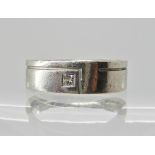 A platinum and diamond wedding band with an unusual finger print design to the interior also