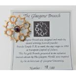 A 9ct gold and garnet broch made by Barbara Temple to commemorate Glasgow's reign in 1990 as the