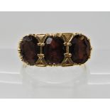 A 9ct gold garnet three stone ring finger size P, weight 3.4gms Condition Report: