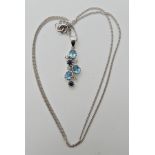 An 18ct gold diamond sapphire and blue topaz pendant and chain weight 4.5gms Condition Report: