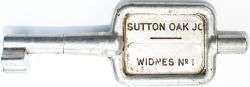 Tyers No9 single line aluminium key token SUTTON OAK JC - WIDNES No1, configuration D. In ex railway