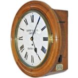 Barry Railway 12in oak cased English fusee railway clock. The case with convex and concave surround,