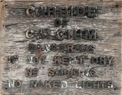 Wood with cast iron lettered sign CARBIDE OF CALCIUM DANGEROUS IF NOT KEPT DRY NO SMOKING NO NAKED