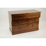 An Edwardian mahogany and chevron strung dressing chest with two break top drawers over two long