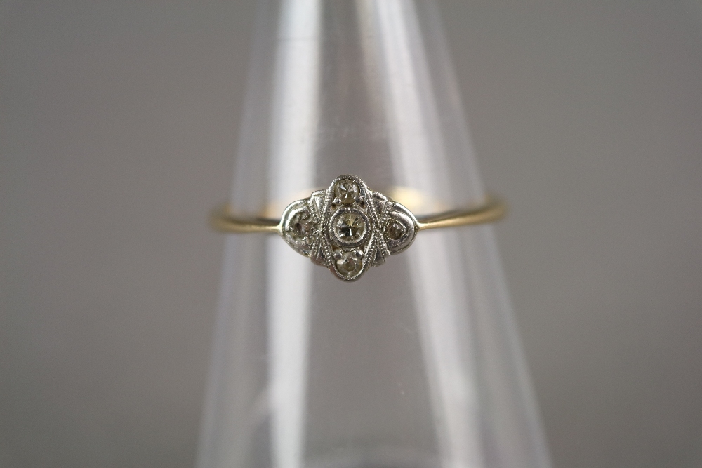 An Art Deco diamond cluster ring, the yellow metal shank stamped '18ct Plat', ring size V, weight 2.