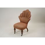 A Victorian walnut framed cloud back easy chair on baluster turned front legs,