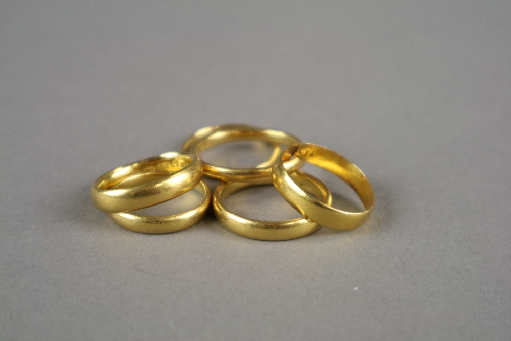 Five 22ct gold wedding bands (one split), together with a yellow metal plain polished wedding band,