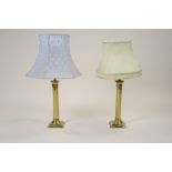 A pair of brass table lamps of plain columnar form each on compressed square base and flat bracket