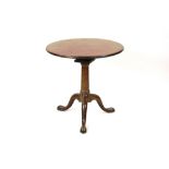 A George II mahogany tripod table the circular tilt top with bird cage action on a plain gun