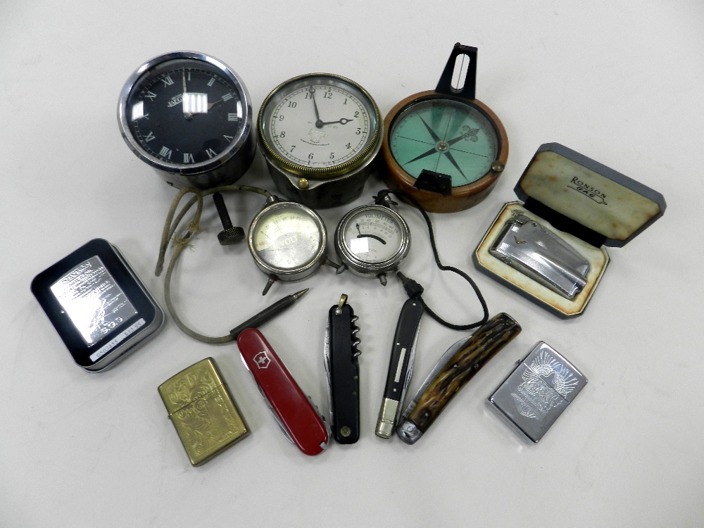 A group of collectables to include two automotive clocks, two volt meters, a prismatic compass,