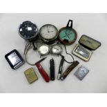 A group of collectables to include two automotive clocks, two volt meters, a prismatic compass,