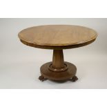 An early Victorian mahogany circular tilt top breakfast table on faceted column,