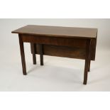 A George III mahogany drop leaf dining table on chamfered grooved square legs, 114cm wide,