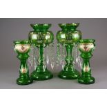A pair of green glass table lustres and matching vases