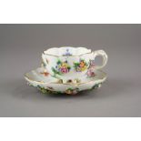 A Meissen porcelain teacup and saucer with relief moulded flowers, late 19th/early 20th century,