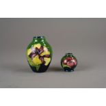 A Moorcroft vase in the Hibiscus pattern against a green ground, 9cm high,