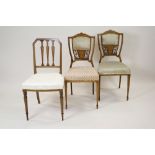 A pair of Edwardian simulated rosewood and inlaid parlour chairs each with silk padded seat and