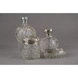 Two silver topped glass circular bottles, hallmarked Birmingham and London,