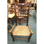 An ash wood rush seat low open armchair,