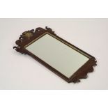 A George II style mahogany and parcel gilt bracket wall mirror with pierced surmount centred by an