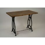 A pine conservatory table on cast iron open work base, 100cm wide, 60cm deep,