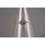 A diamond floral cluster ring, the yellow metal shank stamped '18ct Fine Plat', ring size P,