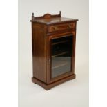 An Edwardian mahogany and inlaid glazed front music cabinet with frieze drawer above a single