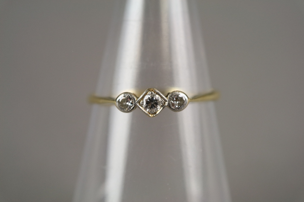 A three stone graduated diamond ring,