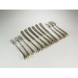 A collection of silver pistol grip cutlery